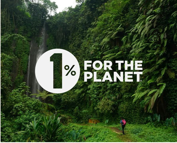 Person walking through a lush green forest with '1% for the Planet' logo overlay.