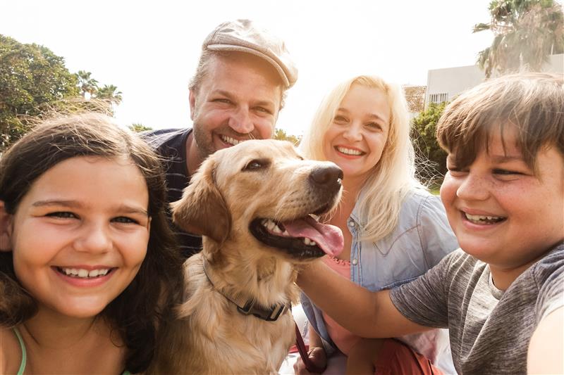 Family of four with a dog outdoors