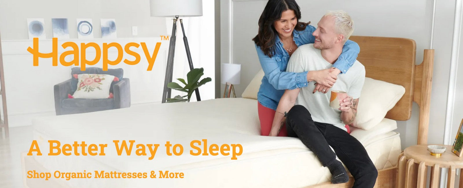 Woman embracing a man on a bed with 'Happsy' mattress branding and promotional text.