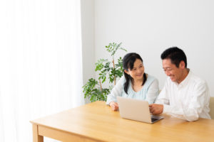 A couple taking an onlone course on a laptop